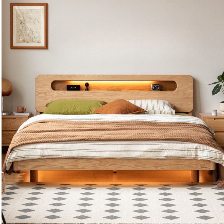 a bed with wooden headboard and foot board in a white room next to a potted plant