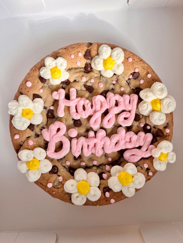 a happy birthday cookie with flowers and chocolate chips