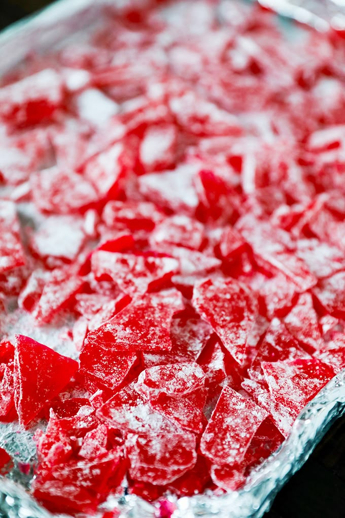 a pan filled with red and white food on top of a stove burner covered in ice