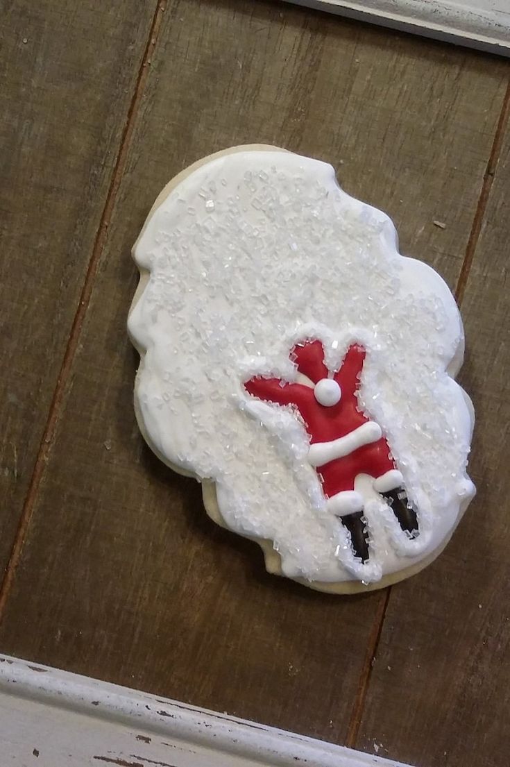 a decorated cookie sitting on top of a wooden table next to a white door frame