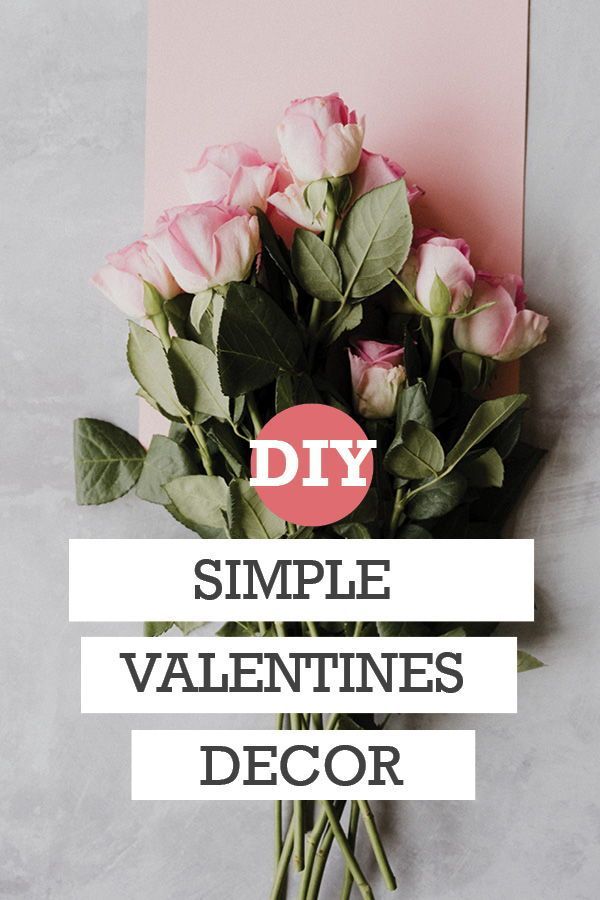 a bouquet of roses sitting on top of a table next to a pink card with the words diy simple valentine's decor