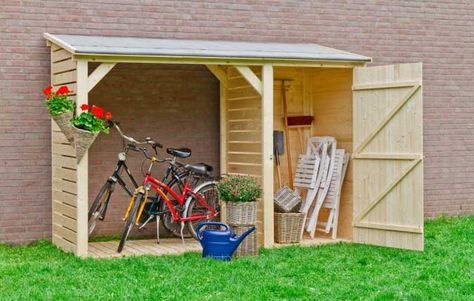 a wooden shed with two bicycles in it