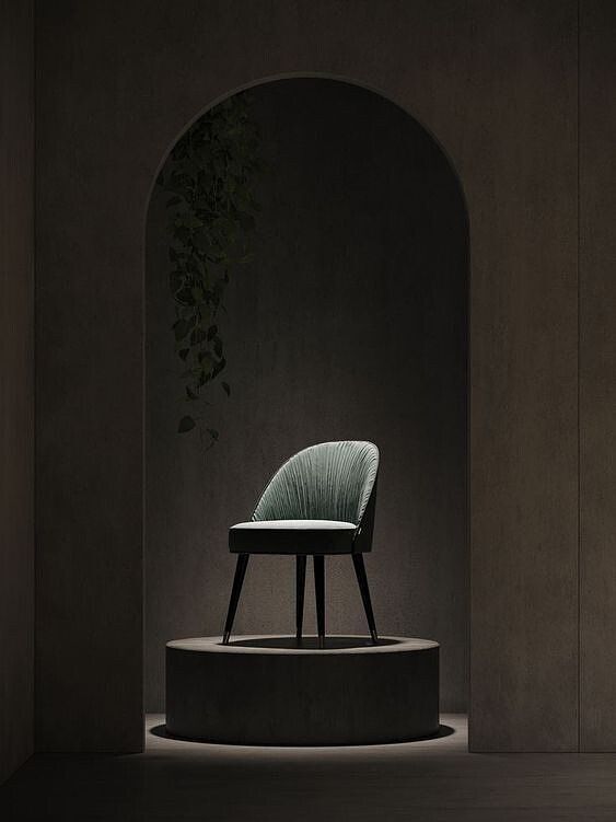 a chair sitting on top of a cement platform next to a plant in an archway