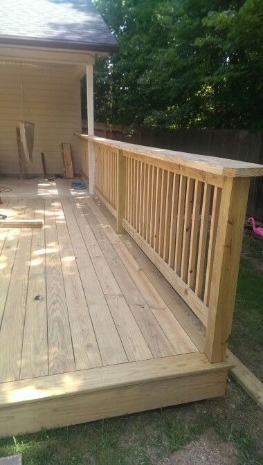 a wooden deck in front of a house