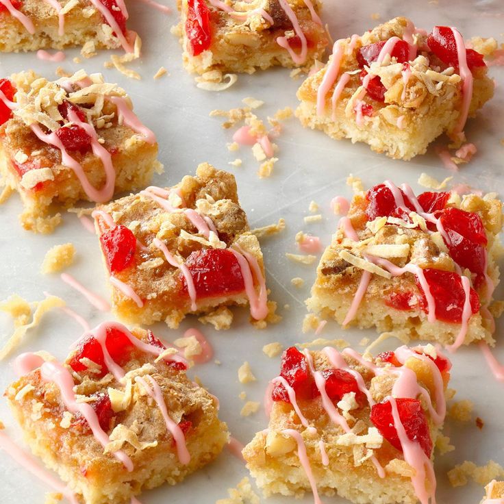 several pieces of cake with pink icing on top