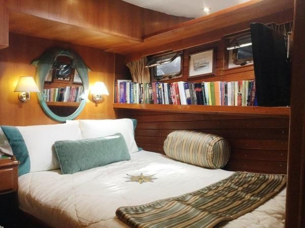 there is a bed in the room with books on the shelves