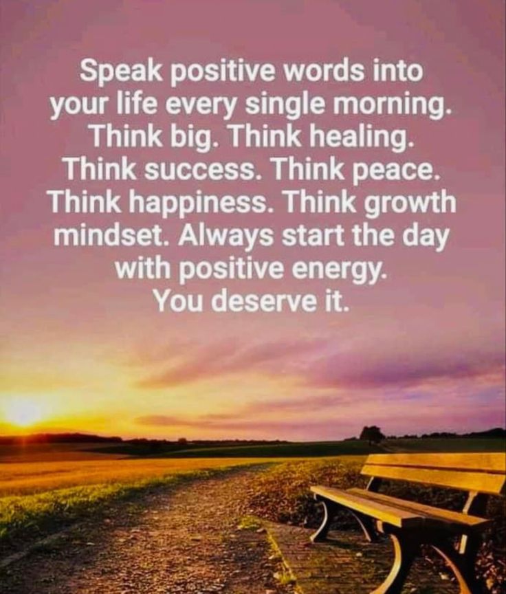 a bench sitting on top of a dirt road next to a field with the words speak positive