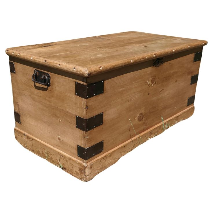 an old wooden trunk is sitting on the ground in front of a white background,