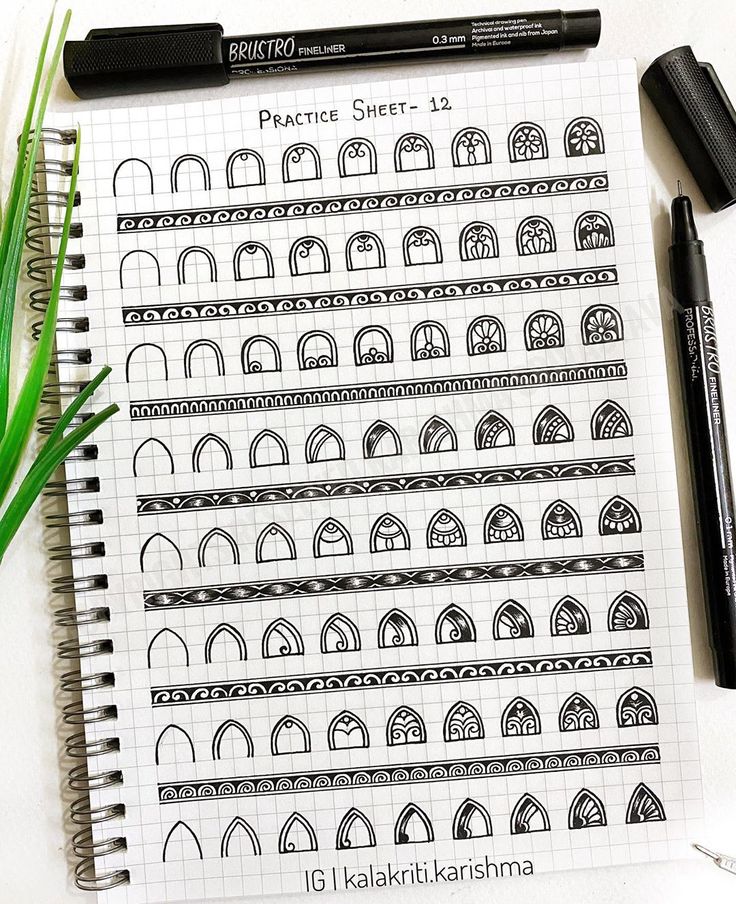 an open notebook with black and white designs on it