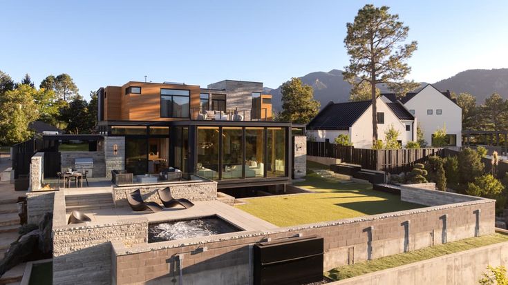 an aerial view of a modern home in the mountains