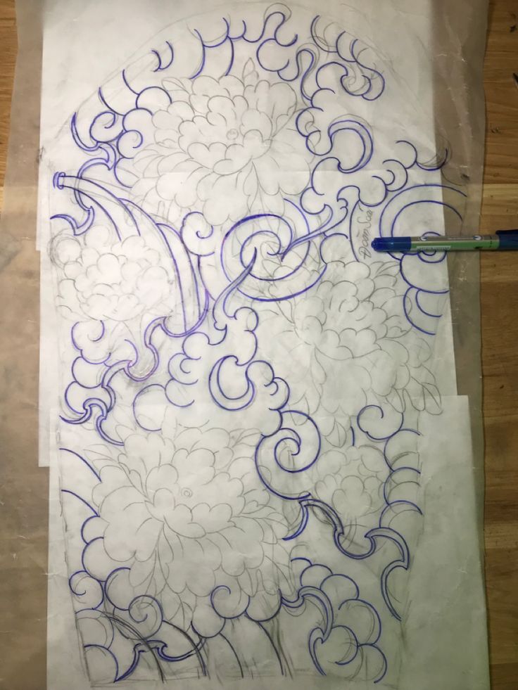 a piece of paper that has been drawn with blue ink and is sitting on a table