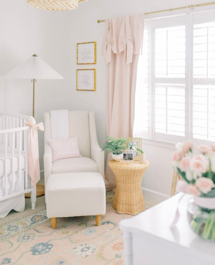 a baby's room is decorated in pink and white