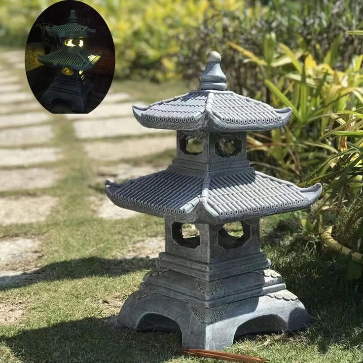 a cat statue in the middle of a garden