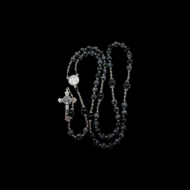 rosary with cross on black background