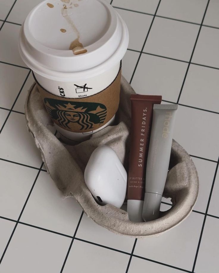 there is a coffee cup and some items in the holder