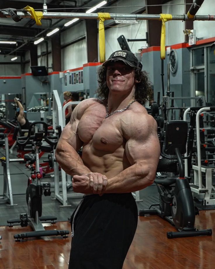 a man posing for the camera in a gym