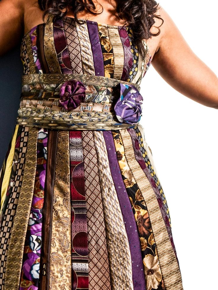 a woman wearing a dress made out of different fabrics