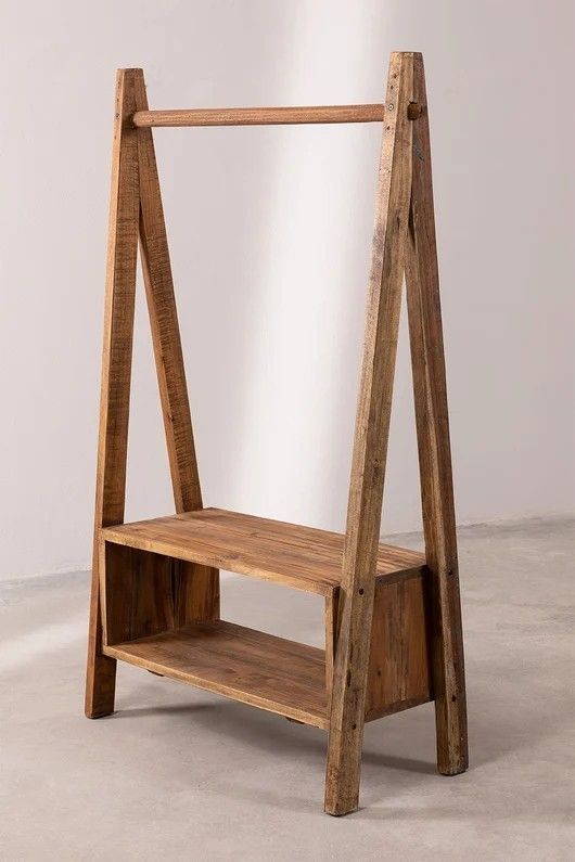 a wooden shelf sitting on top of a cement floor