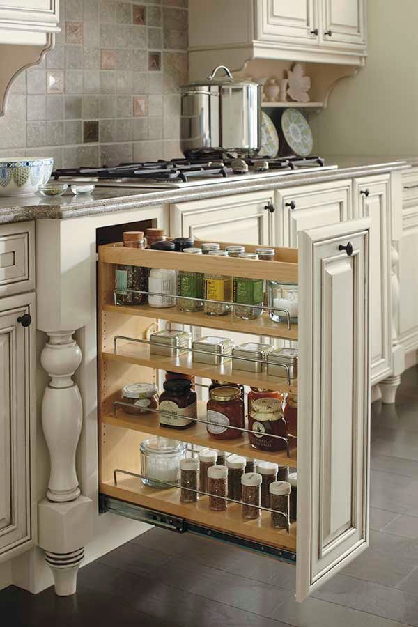 an open cabinet in the middle of a kitchen