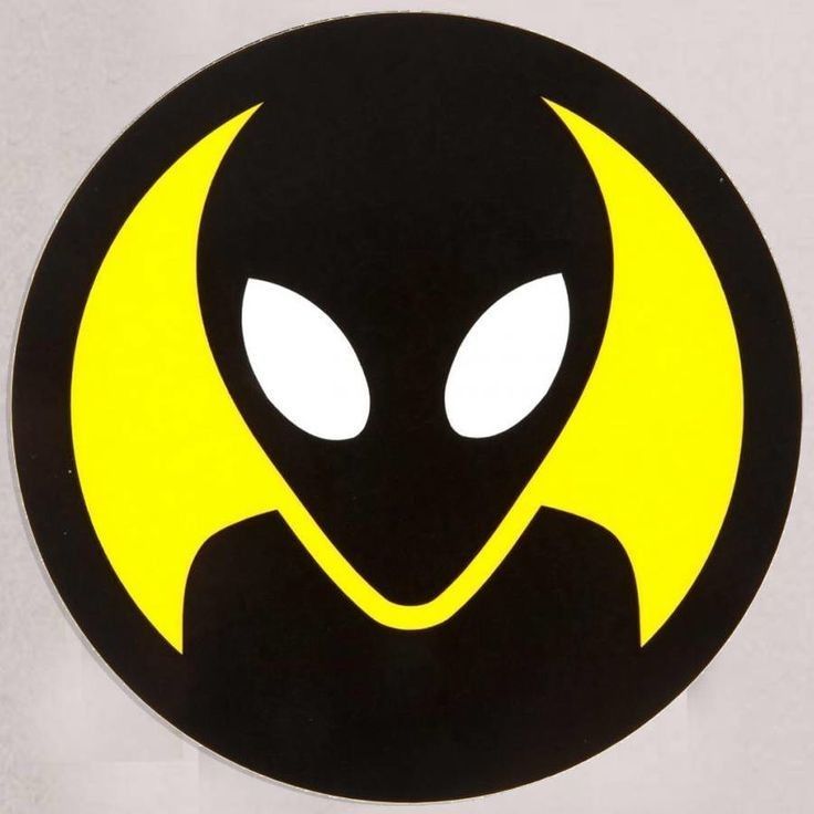 a black and yellow sticker with an alien face on it's side,