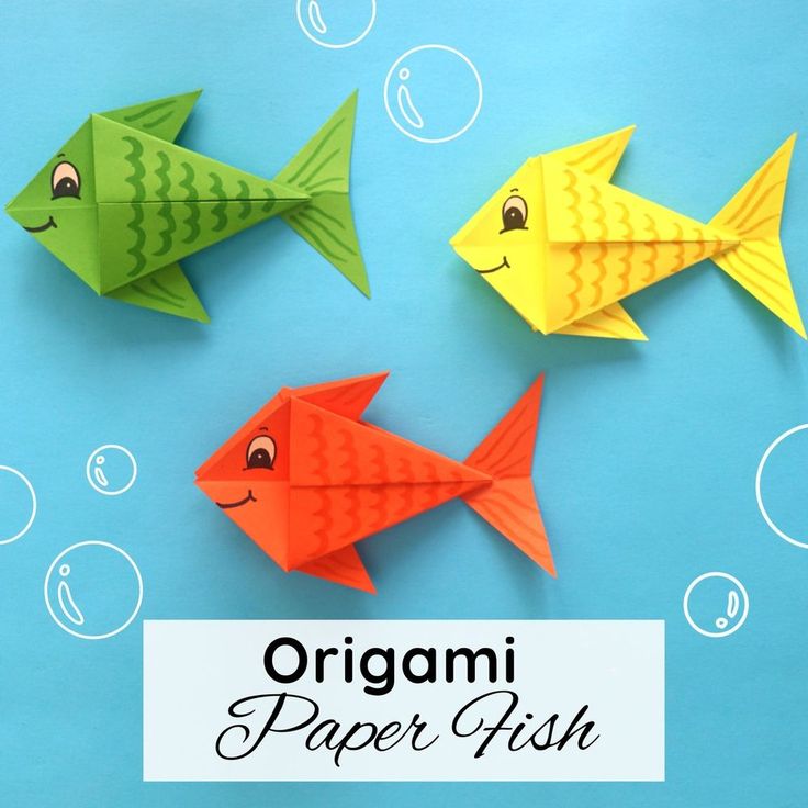 three origami paper fish on a blue surface with bubbles around them and the words, origami paper fish