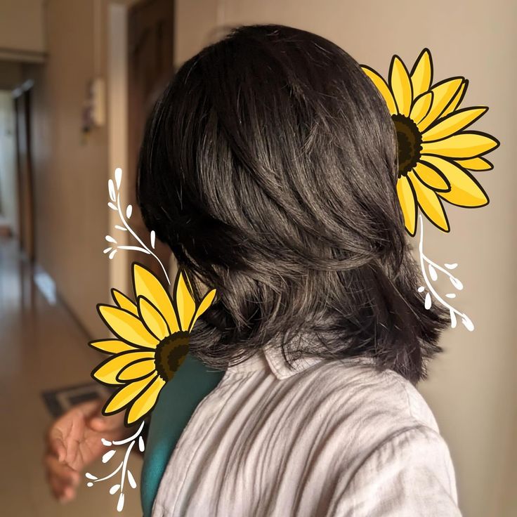 the back of a woman's head with sunflowers in her hair,