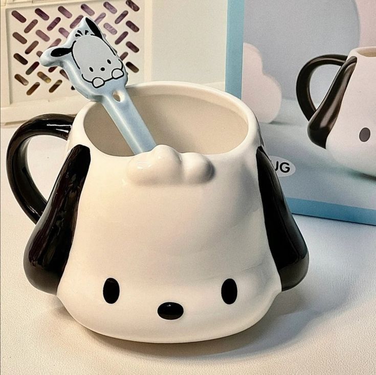 a hello kitty mug with a toothbrush in it