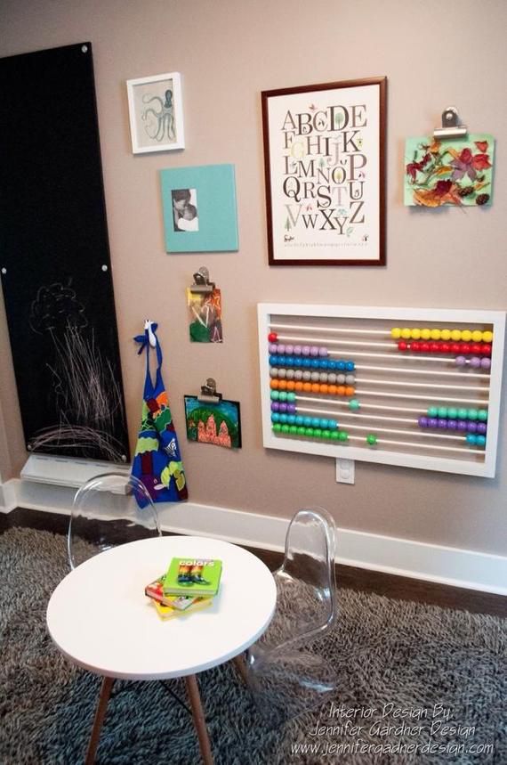 a child's room with toys and art on the wall