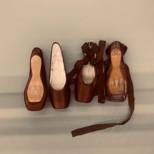 four pairs of shoes are lined up in a row