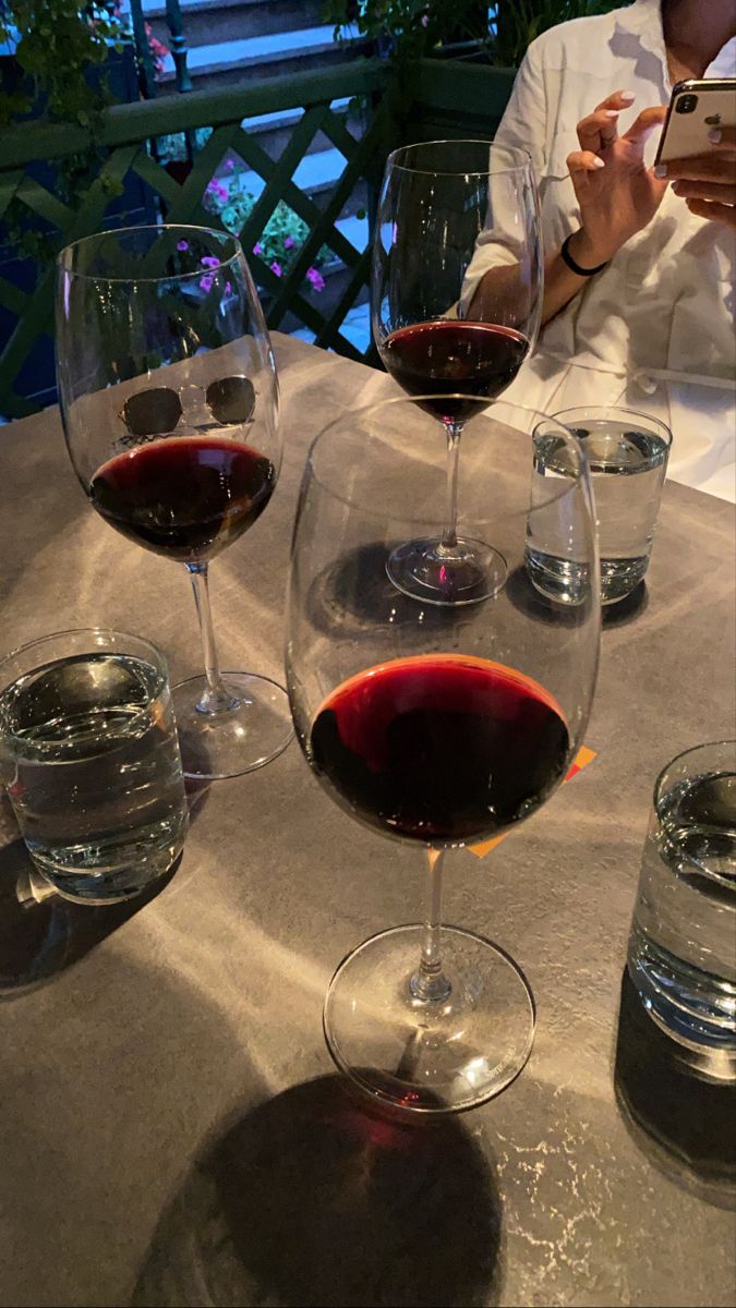 several glasses of wine are sitting on a table