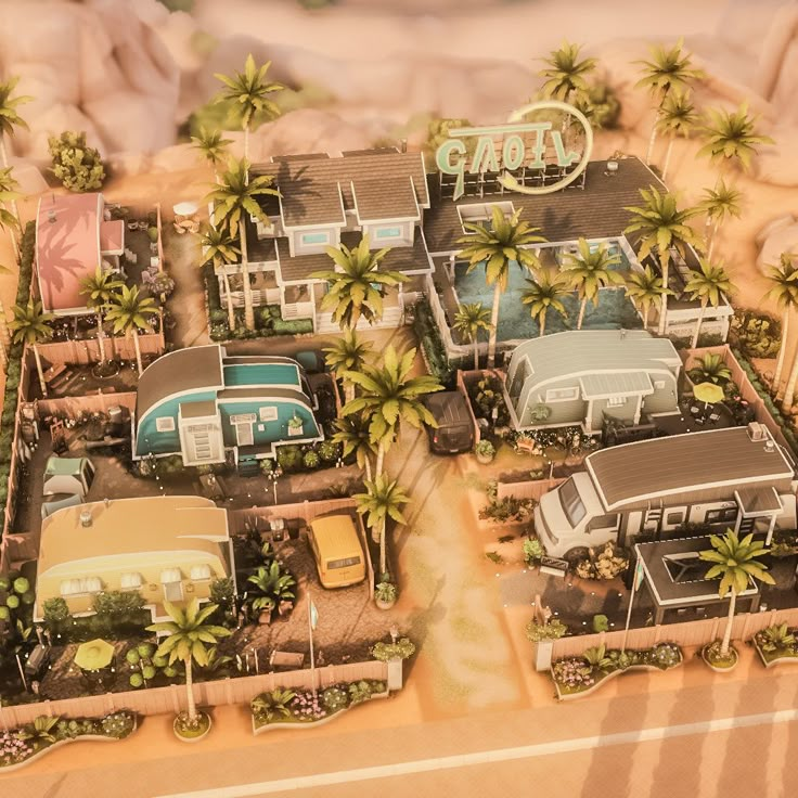 an aerial view of a motel surrounded by palm trees and parked cars on the beach