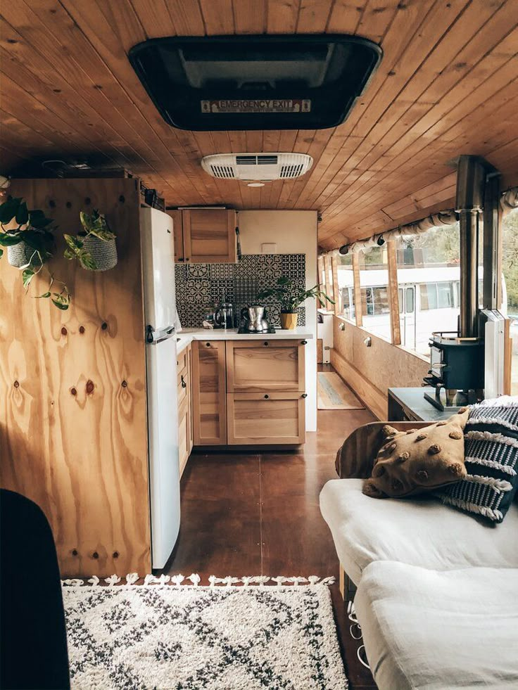 the interior of an rv with wood paneling on the walls and ceiling is clean