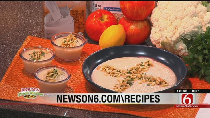 some food is sitting on a table with oranges and cauliflower next to it