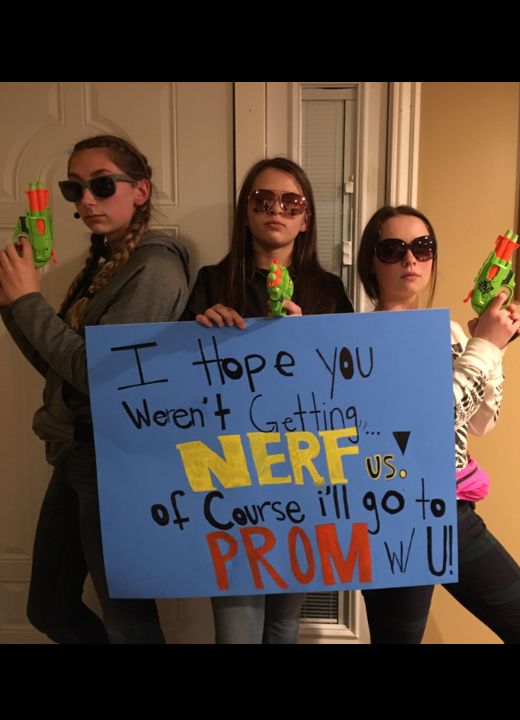 three girls holding up signs in front of a door that say i hope you were cutting here cause ill go to prom