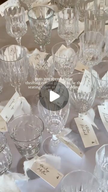 a table topped with lots of glassware and place cards on top of each other