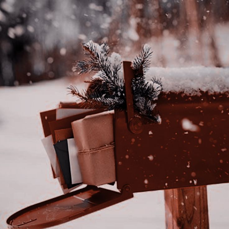 a mailbox covered in snow with christmas decorations