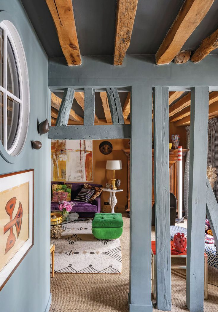 a room with blue walls and wooden beams