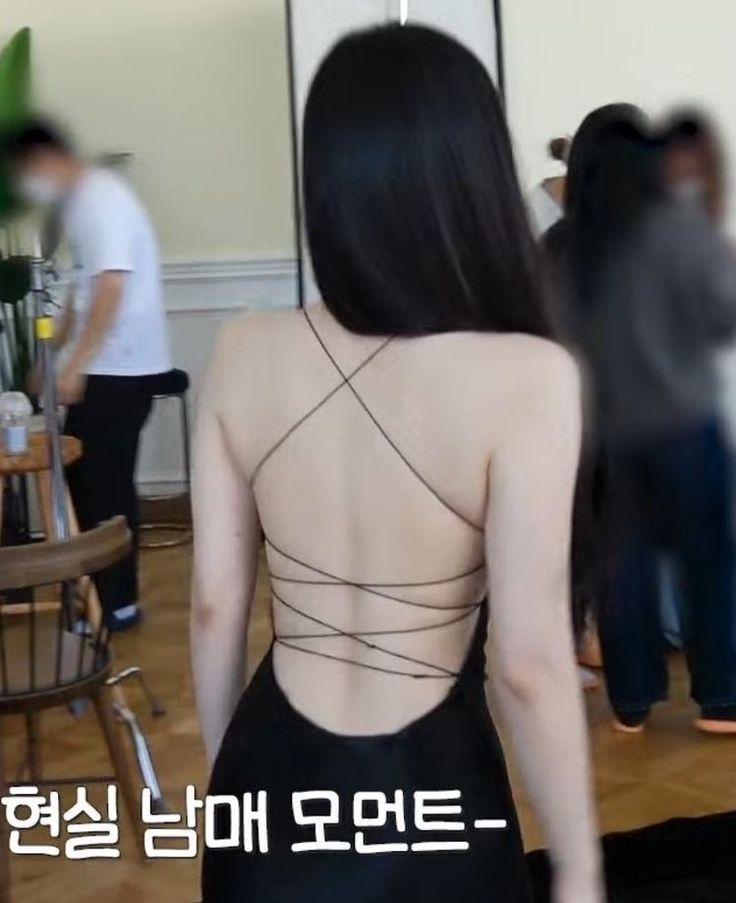 the back of a woman in a black dress