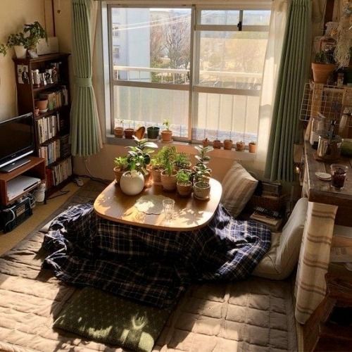 a living room filled with furniture and a flat screen tv sitting on top of a wooden table