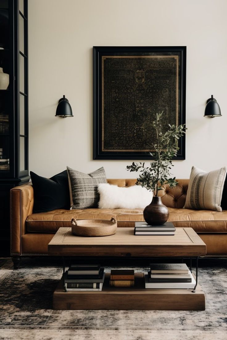 a living room with a couch, coffee table and lamps on the wall above it