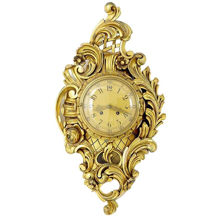 an ornate gold clock hanging on the wall