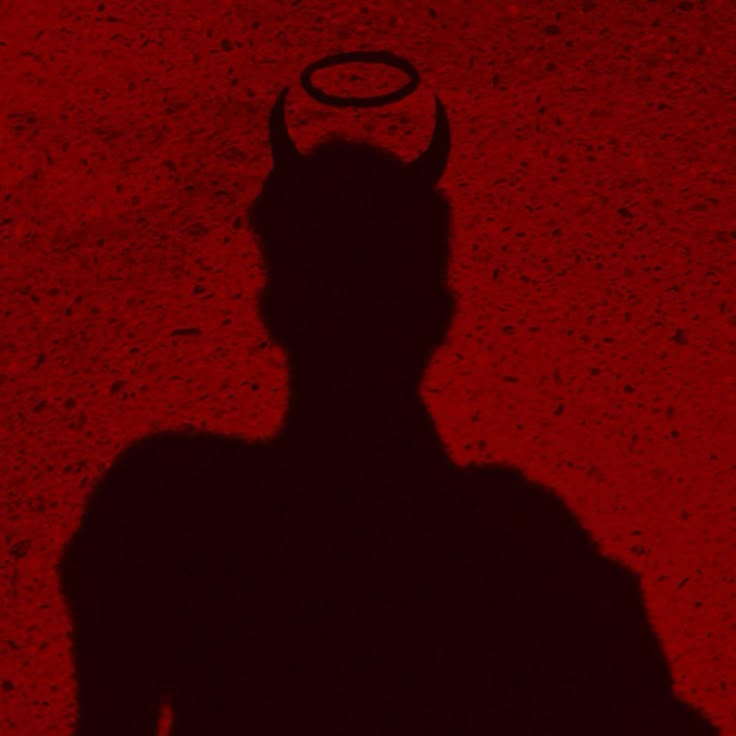 the shadow of a devil with horns on it's head