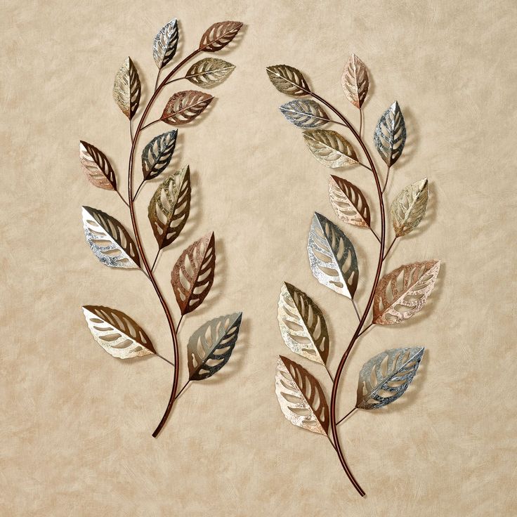 two metal leaves on a beige background