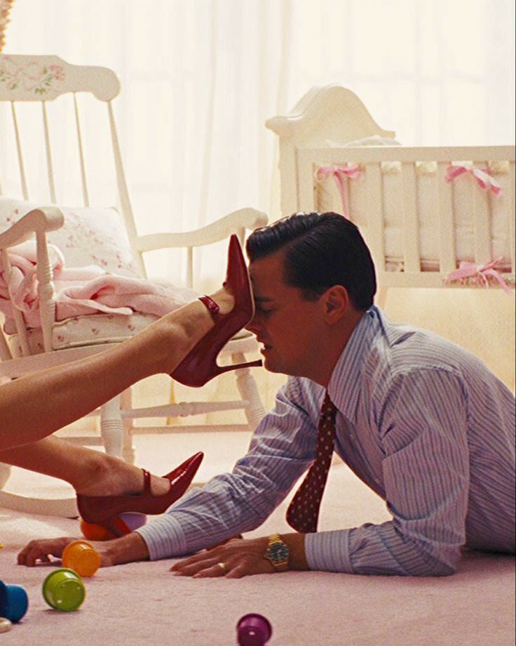 a man and woman laying on the floor playing with balls