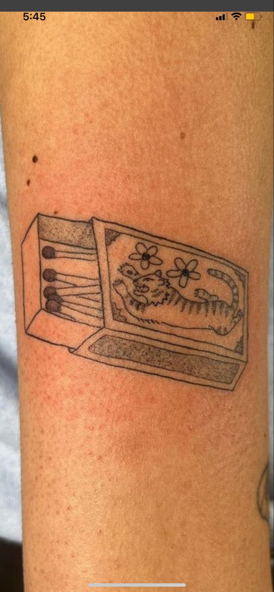 a tattoo with an open box on it