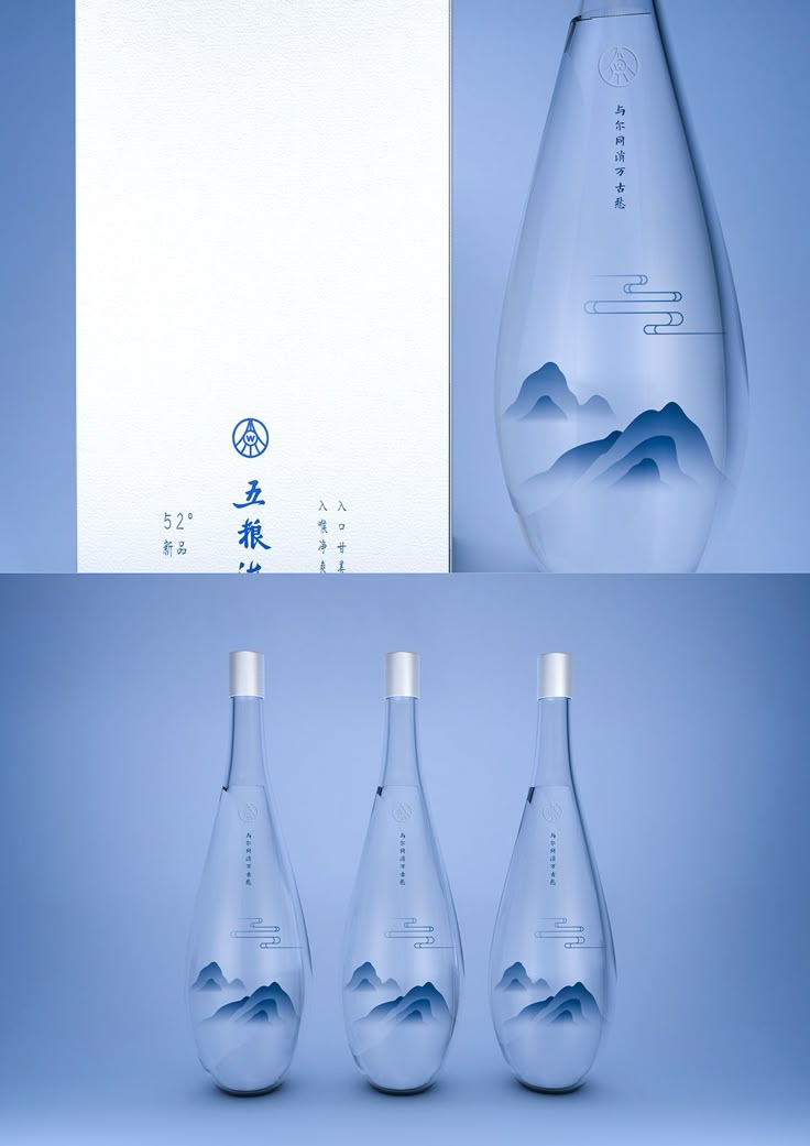 three empty water bottles with mountains in the background and an envelope behind them on a blue surface