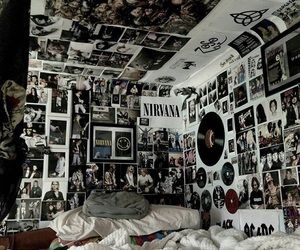 a bedroom with many pictures on the wall