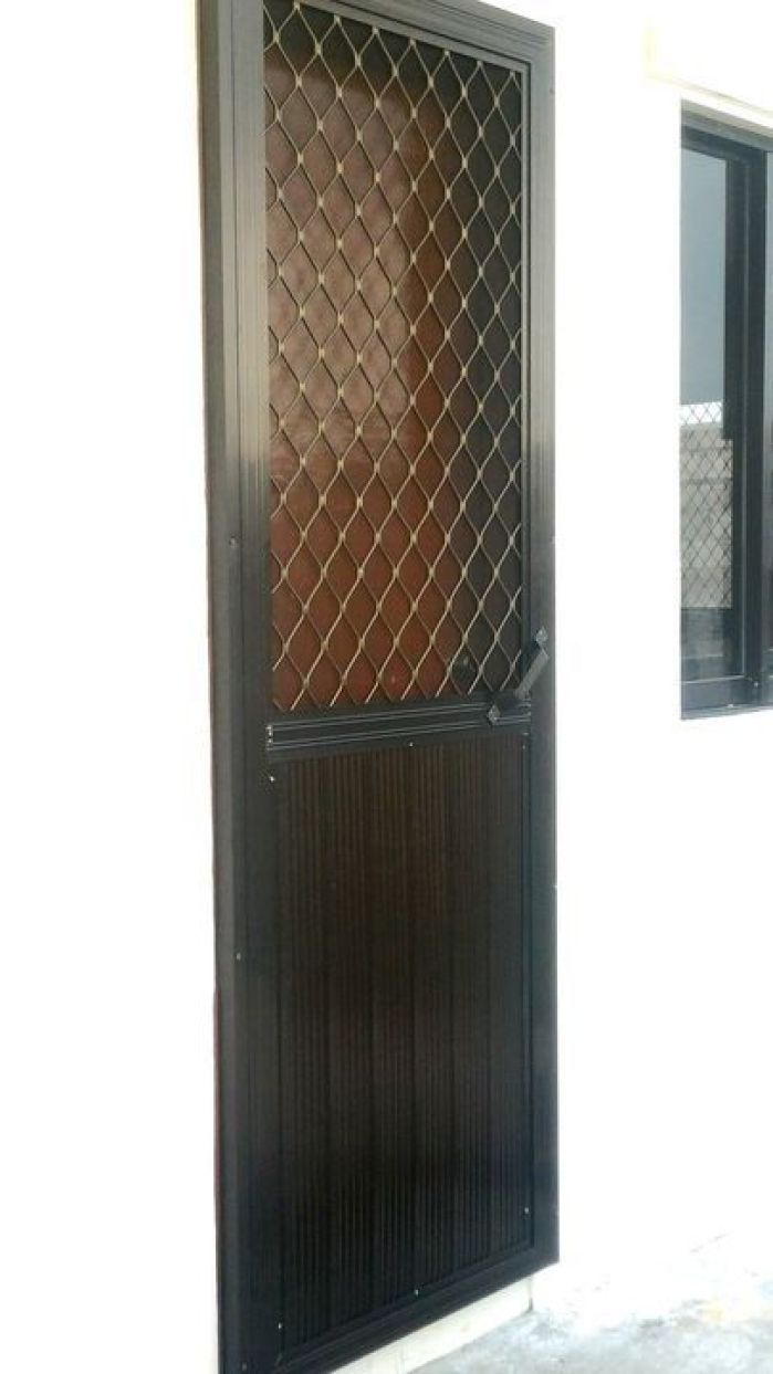 the door is made of wood and has a metal grid design on it's side