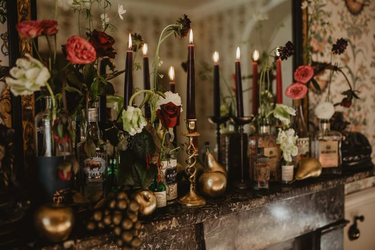 a mantle with candles and flowers on it