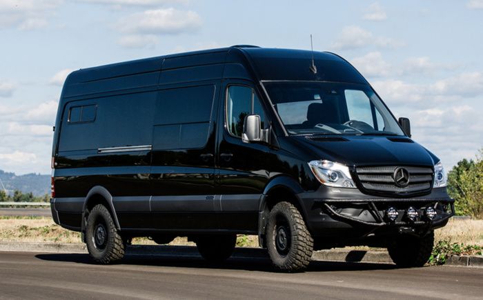 a black van is parked on the side of the road